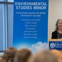 A faculty member welcomes the attendees to the event.